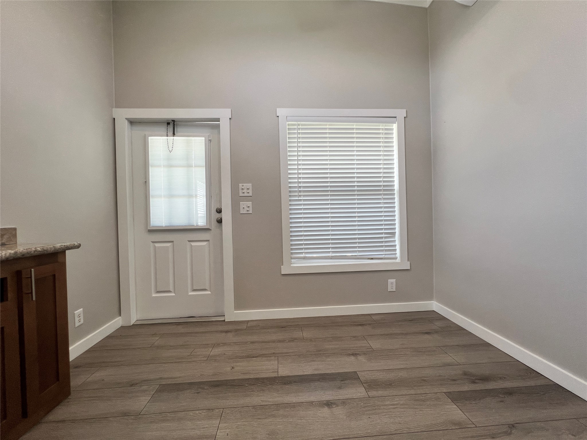 103 Pitts Road, Unit C Richmond, TX 77406 - Photo 4 of 12 a view of an empty room with wooden floor and a window