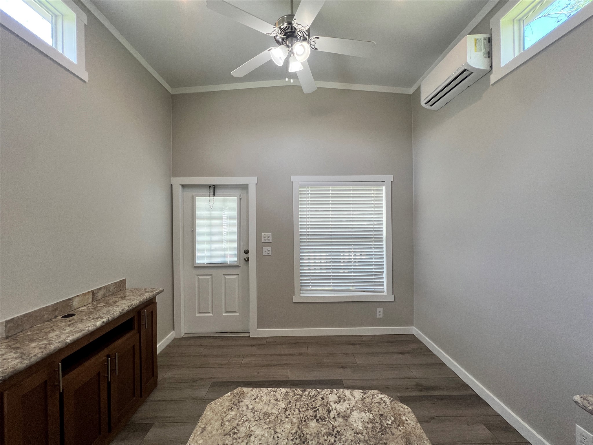 103 Pitts Road, Unit C Richmond, TX 77406 - Photo 5 of 12 an empty room with wooden floor cabinet and windows