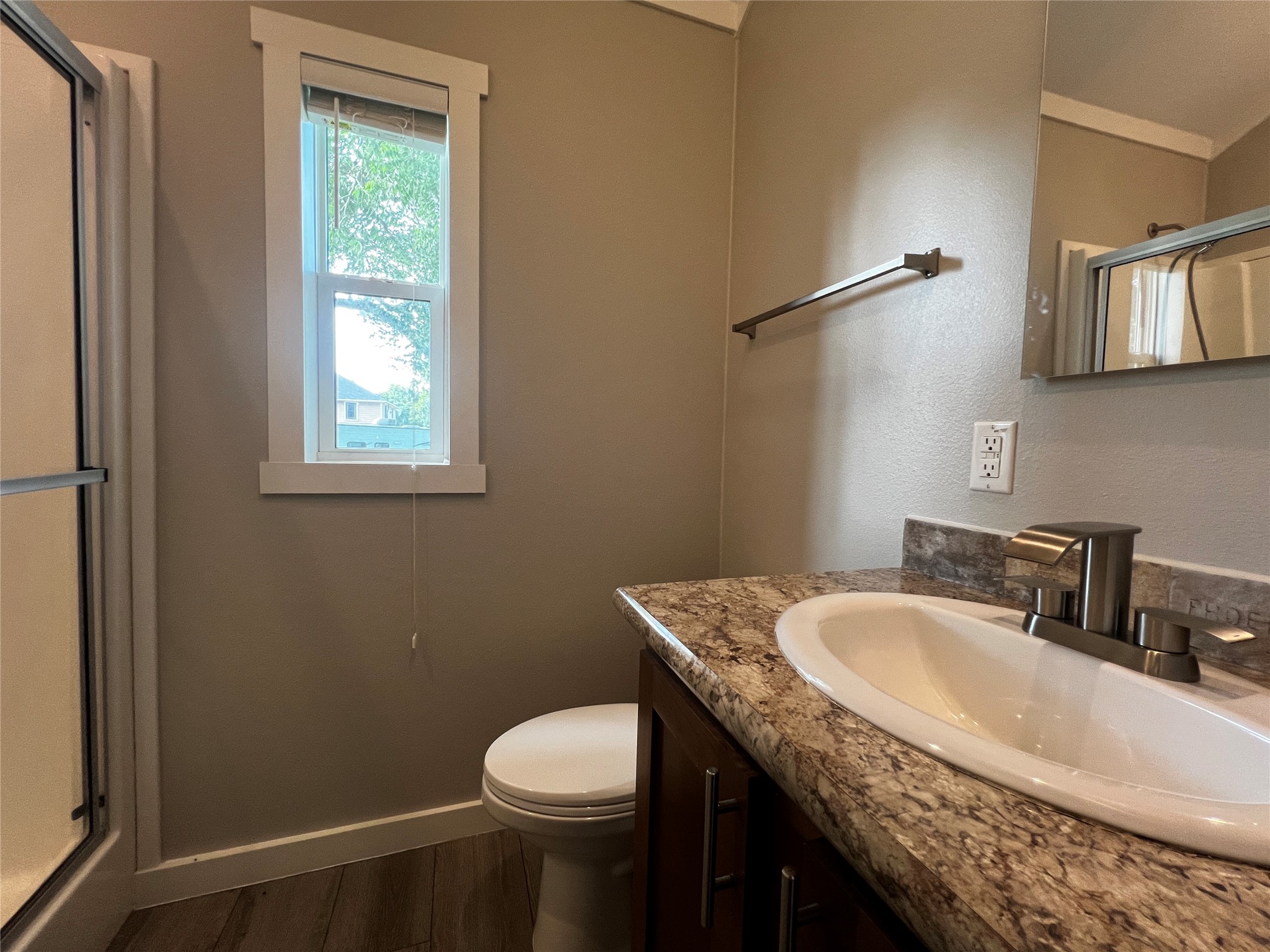 103 Pitts Road, Unit C Richmond, TX 77406 - Photo 9 of 12 a bathroom with a granite countertop sink a toilet and mirror