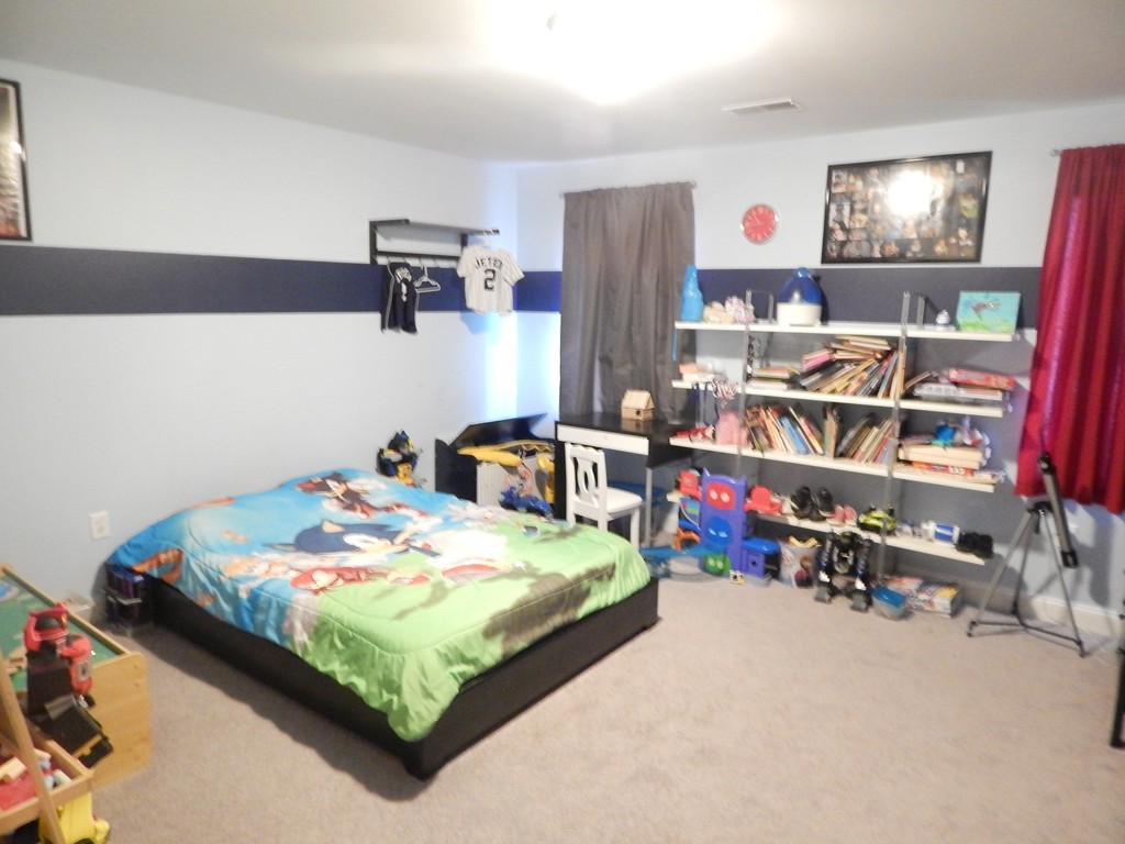 530 Stevens Street Fall River, MA 02721 - Photo 16 of 22 a bedroom with bed and a baby bed