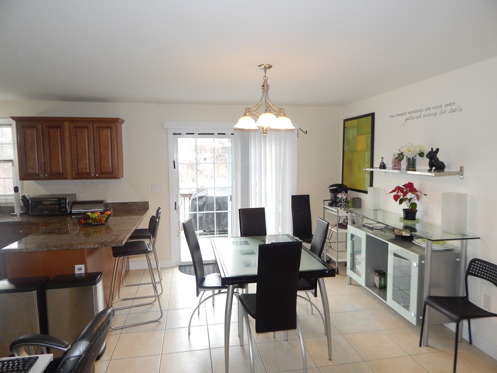 530 Stevens Street Fall River, MA 02721 - Photo 7 of 22 a view of a dining room with furniture and chandelier