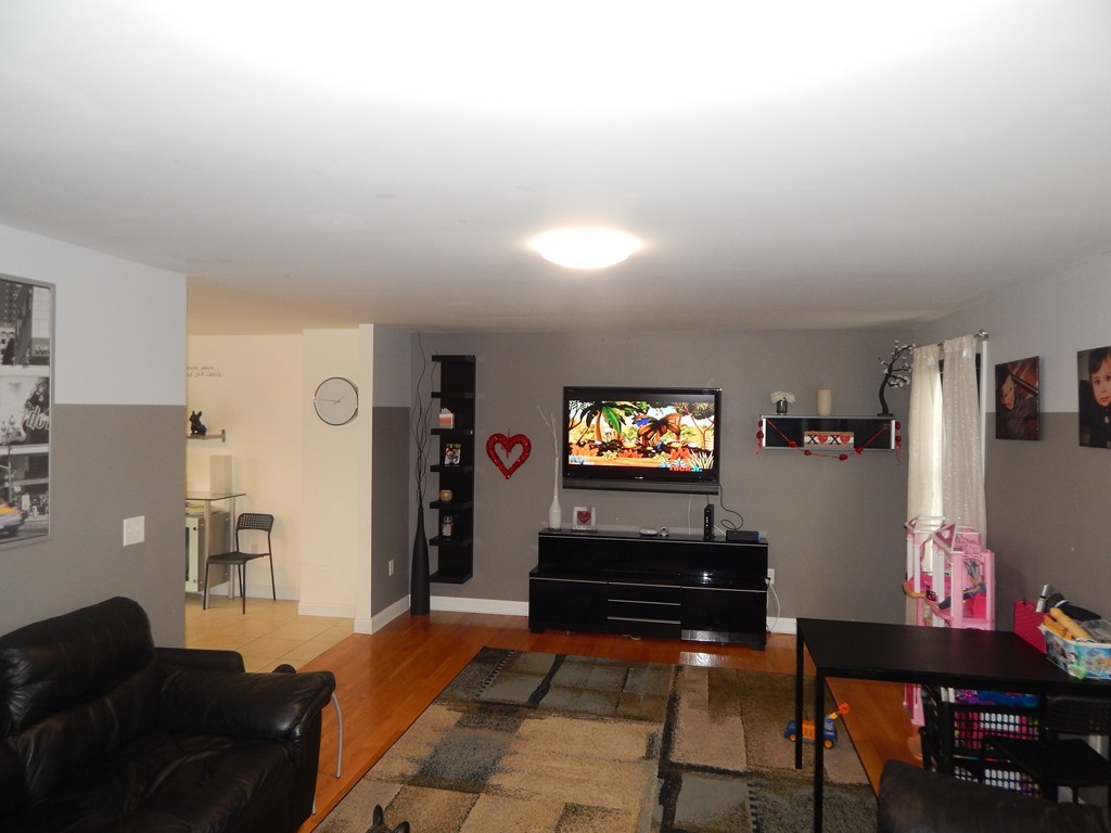 530 Stevens Street Fall River, MA 02721 - Photo 9 of 22 a living room with furniture and a flat screen tv