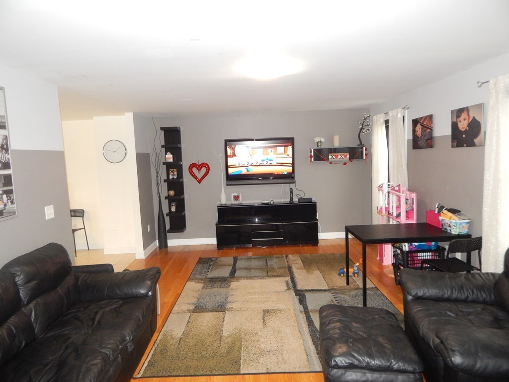 530 Stevens Street Fall River, MA 02721 - Photo 10 of 22 a living room with furniture and a flat screen tv