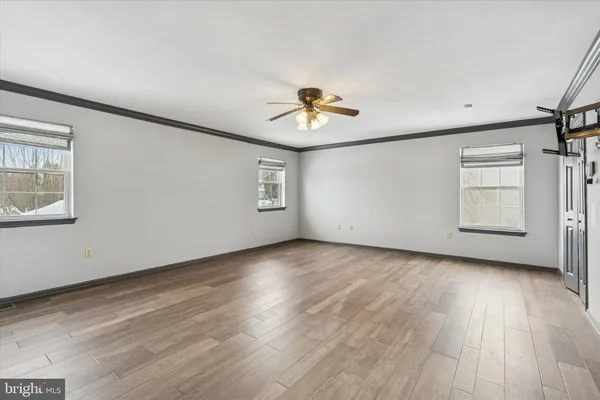 a bathroom with a white tub a toilet a sink and a window