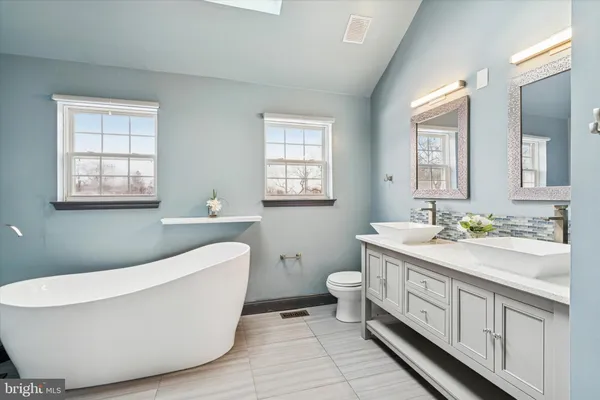 a bathroom with a bathtub and a shower