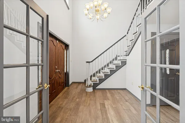 a view of entryway and hall with wooden floor