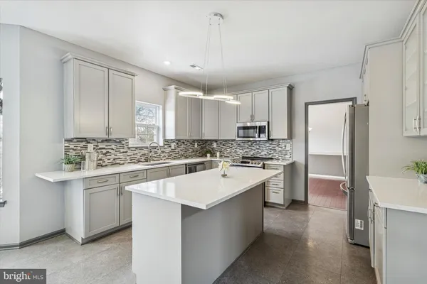 a kitchen with a sink stove and refrigerator