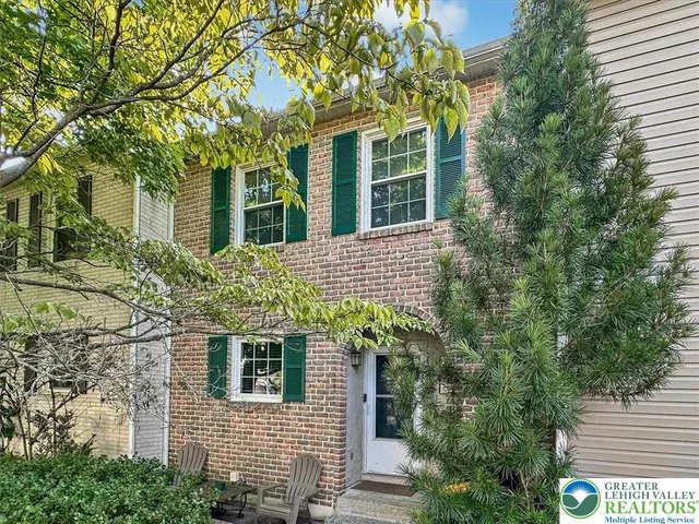 a front view of a house with plants
