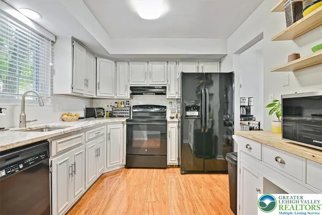a kitchen with a refrigerator stove and sink