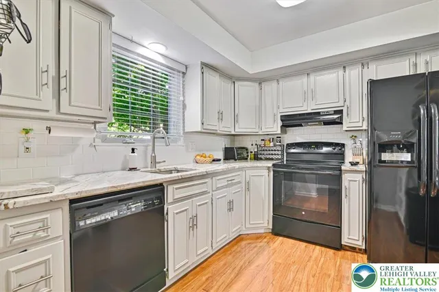 a kitchen with a sink stove and cabinets
