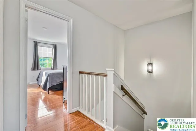 a view of a hallway to a livingroom with furniture