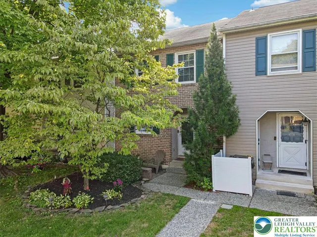 a view of a house with a yard and plants