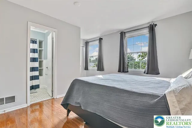 a bedroom with a bed and a large window