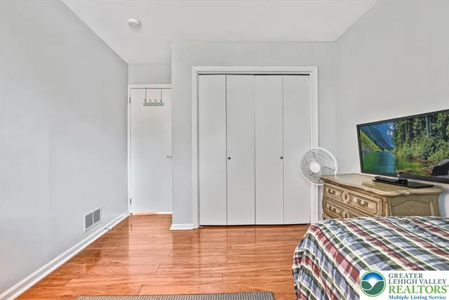 a bedroom with a bed and a flat screen tv