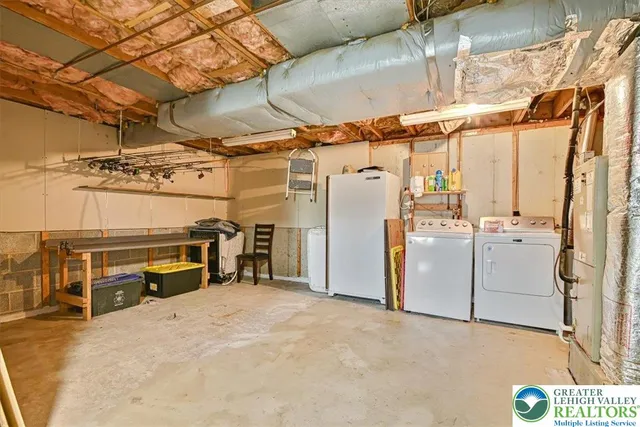 a view of front of a house with many windows next to a yard