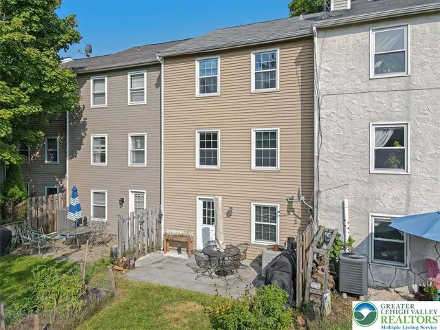 a couple of chairs sitting in front of a house