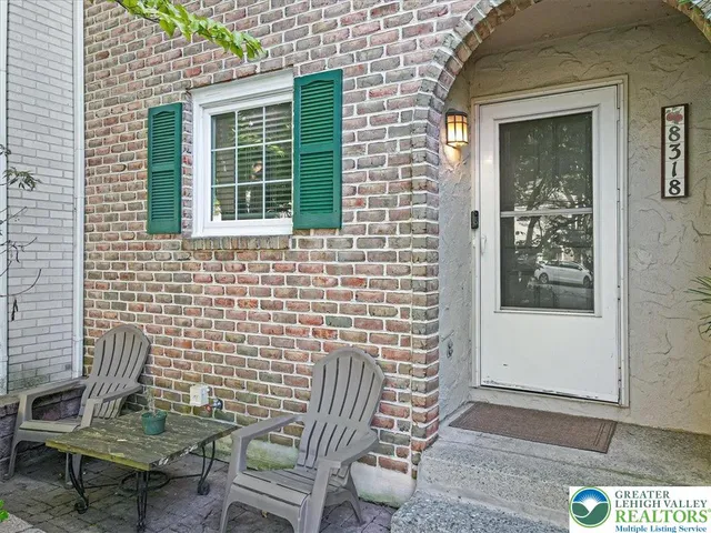 a view of a door with a chairs and a porch