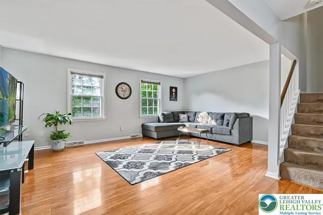 a living room with furniture and wooden floor