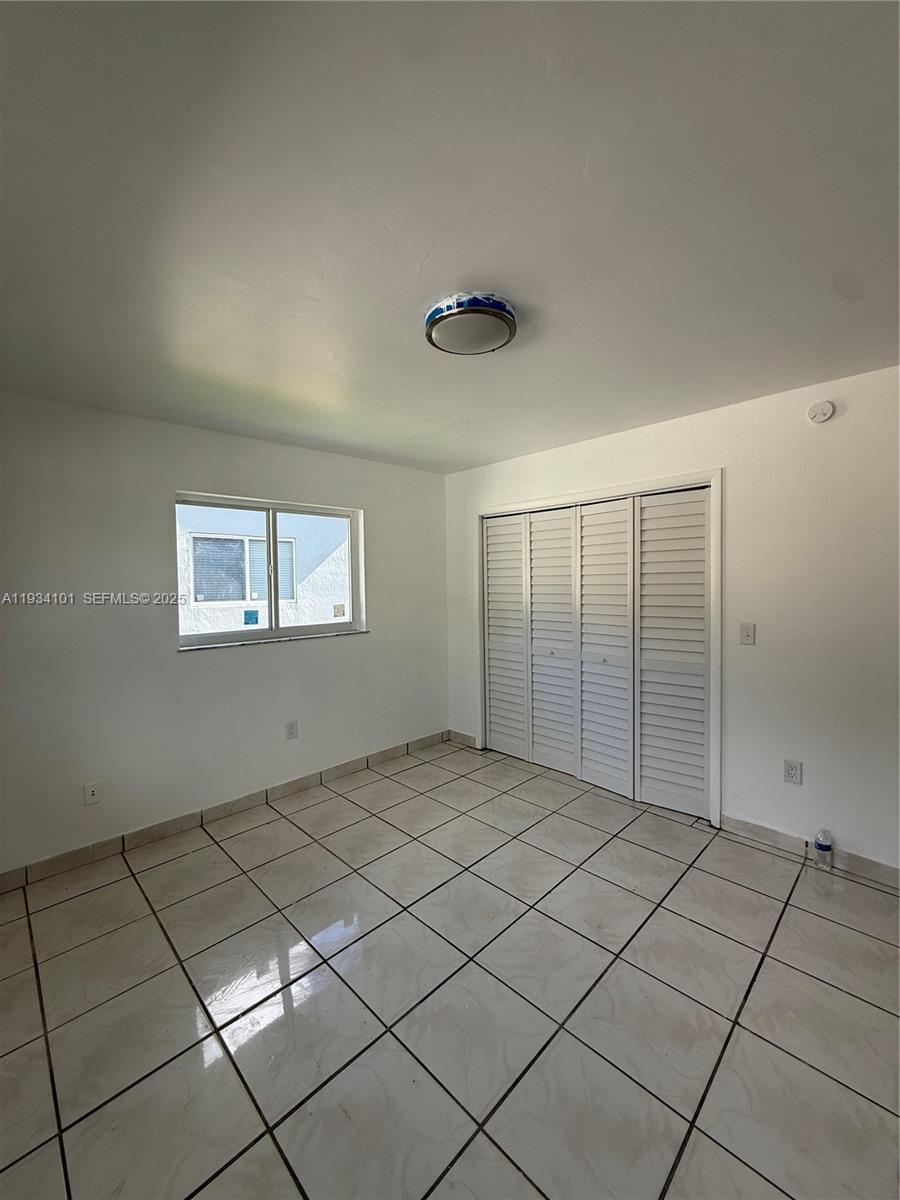 1055 Northwest 34th Avenue, Unit 1055 Miami, FL 33125 - Photo 14 of 19 a view of an empty room