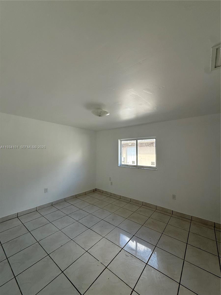 1055 Northwest 34th Avenue, Unit 1055 Miami, FL 33125 - Photo 19 of 19 an empty room with windows