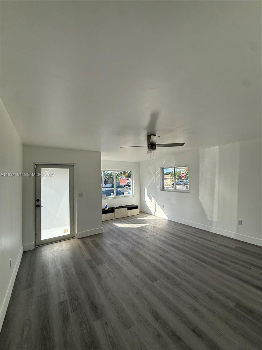 1055 Northwest 34th Avenue, Unit 1055 Miami, FL 33125 - Photo 5 of 19 a view of a livingroom with wooden floor