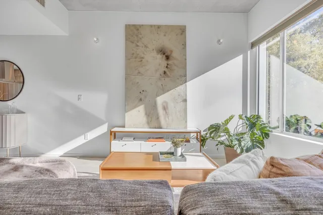 a living room with furniture and large windows