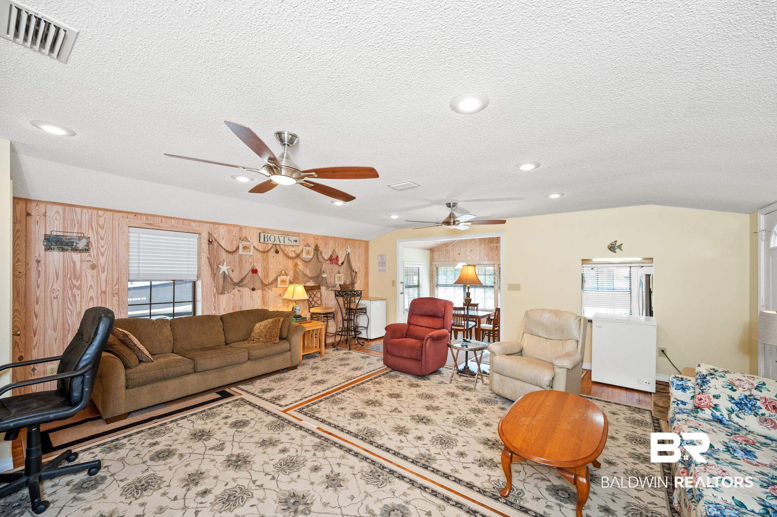 5392 Ornacor Avenue Orange Beach, AL 36561 - Photo 16 of 48 Living room featuring ceiling fan, light wood-type flooring, and a textured ceiling