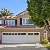 a front view of a house with a yard garage and outdoor seating