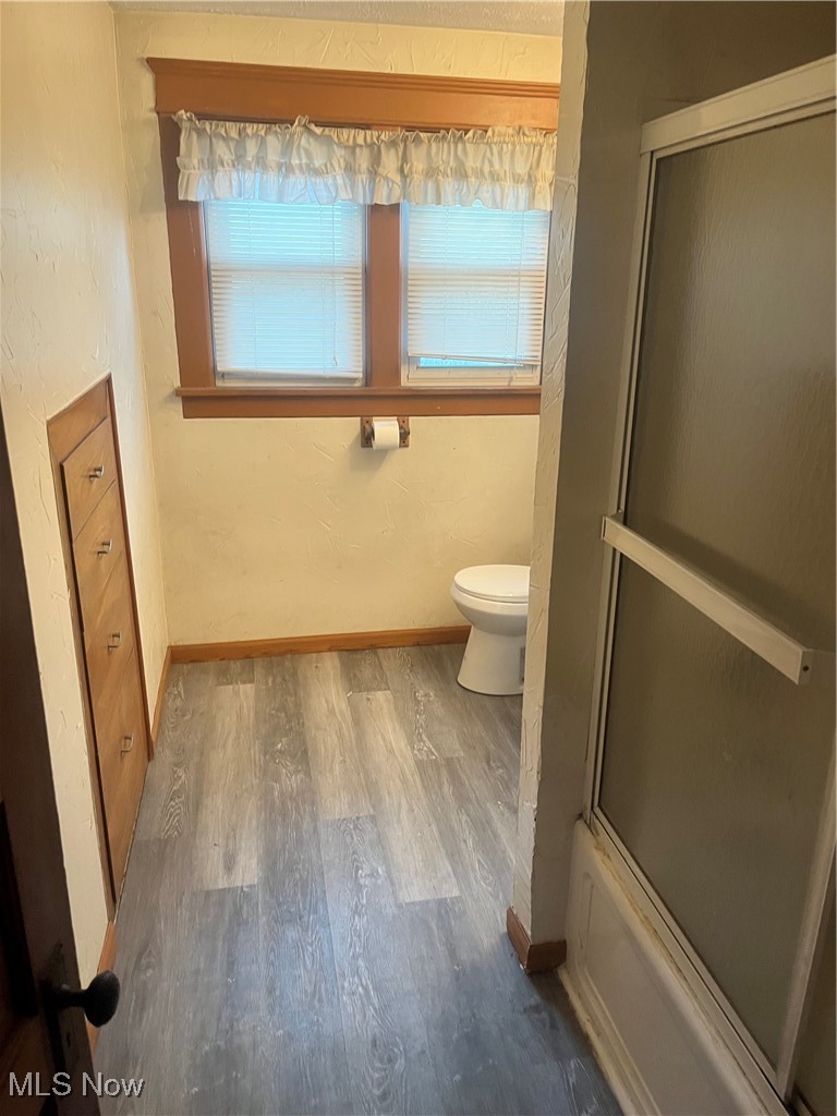 232 Selby Street Alliance, OH 44601 - Photo 11 of 15 Full bath with toilet, baseboards, and wood finished floors