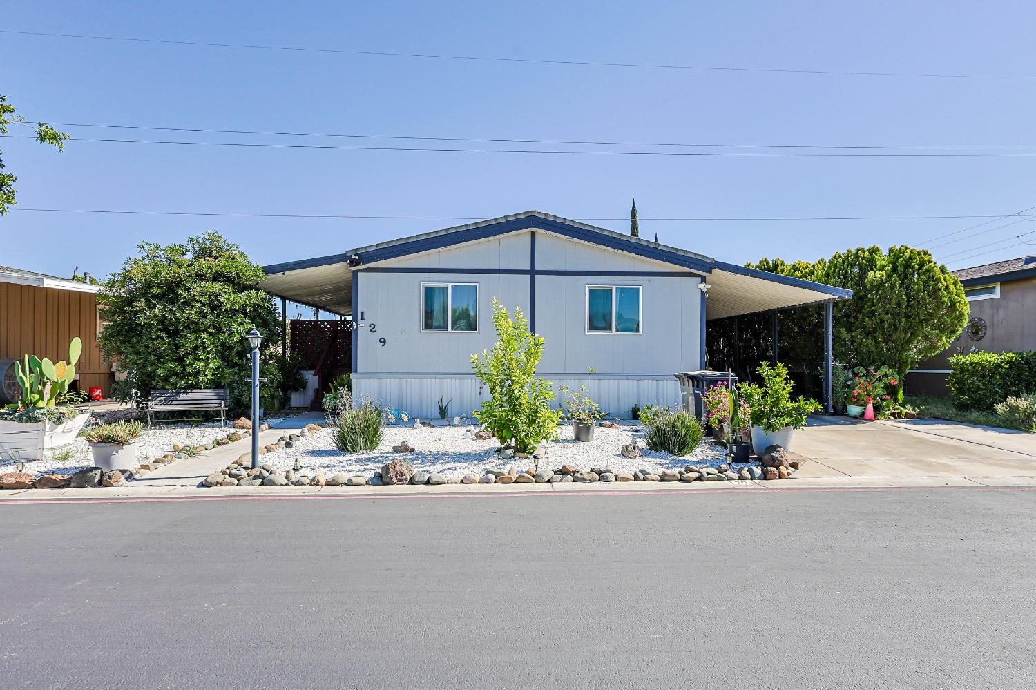 3950 Mack Road, Unit 129 Sacramento, CA 95823 - Photo 1 of 35 a front view of a house with a garden and mountain view