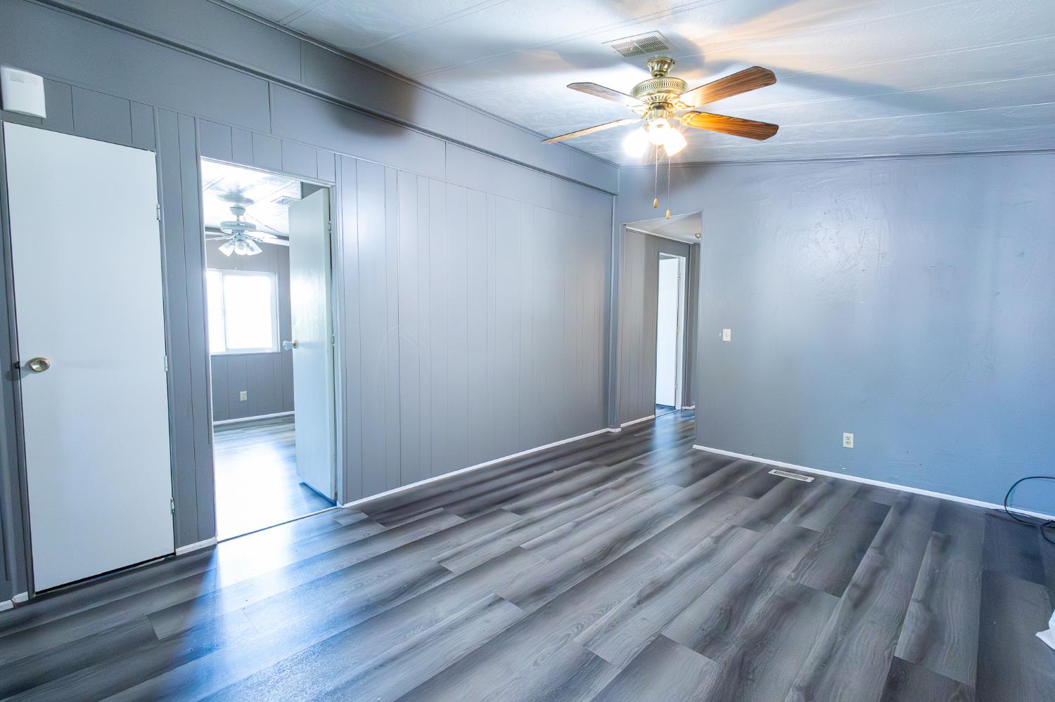 3950 Mack Road, Unit 129 Sacramento, CA 95823 - Photo 12 of 35 a view of an empty room with window and wooden floor
