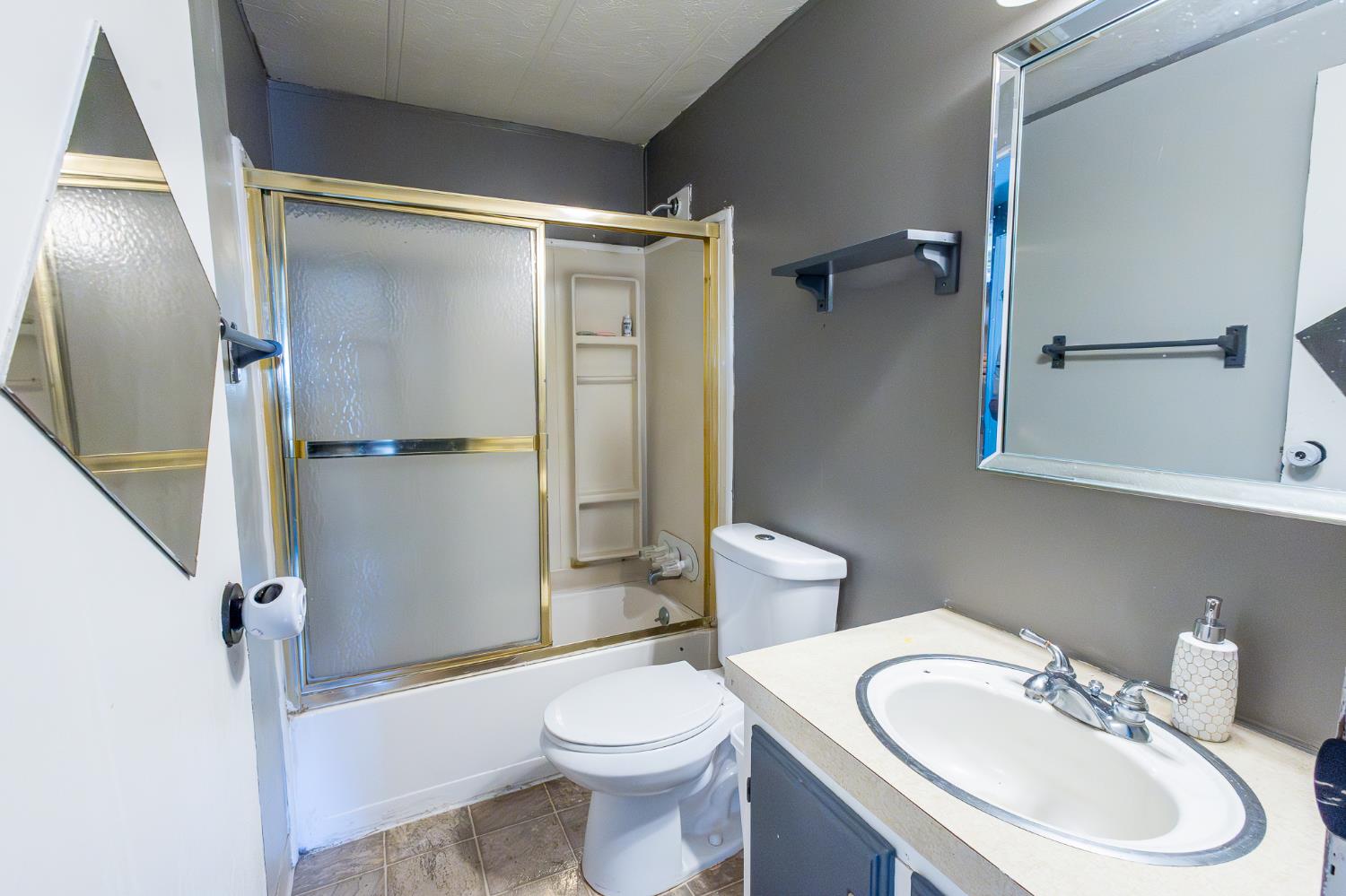 3950 Mack Road, Unit 129 Sacramento, CA 95823 - Photo 17 of 35 a bathroom with a sink toilet and shower