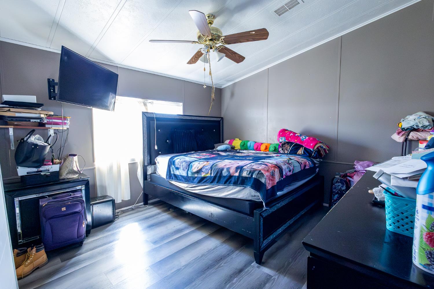 3950 Mack Road, Unit 129 Sacramento, CA 95823 - Photo 19 of 35 a bedroom with a bed and a chandelier