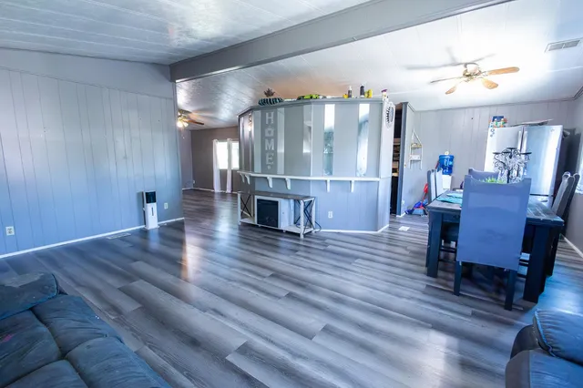 a view of a room with furniture and wooden floor