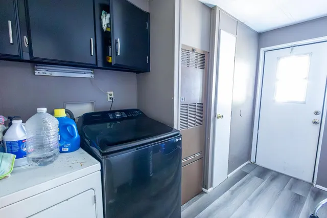 a kitchen with a stove and a wooden cabinets