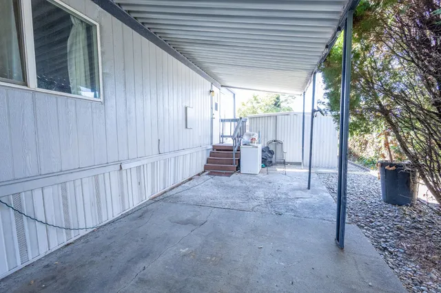 a view of house with yard and outdoor seating