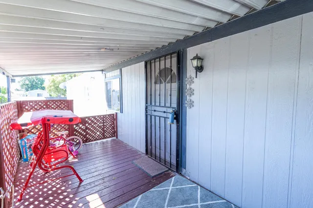 a view of a livingroom with wooden floor and furniture