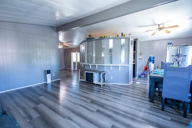 a view of a livingroom with furniture wooden floor and window