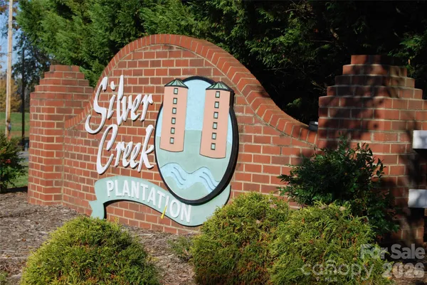 a view of a sign board with plants