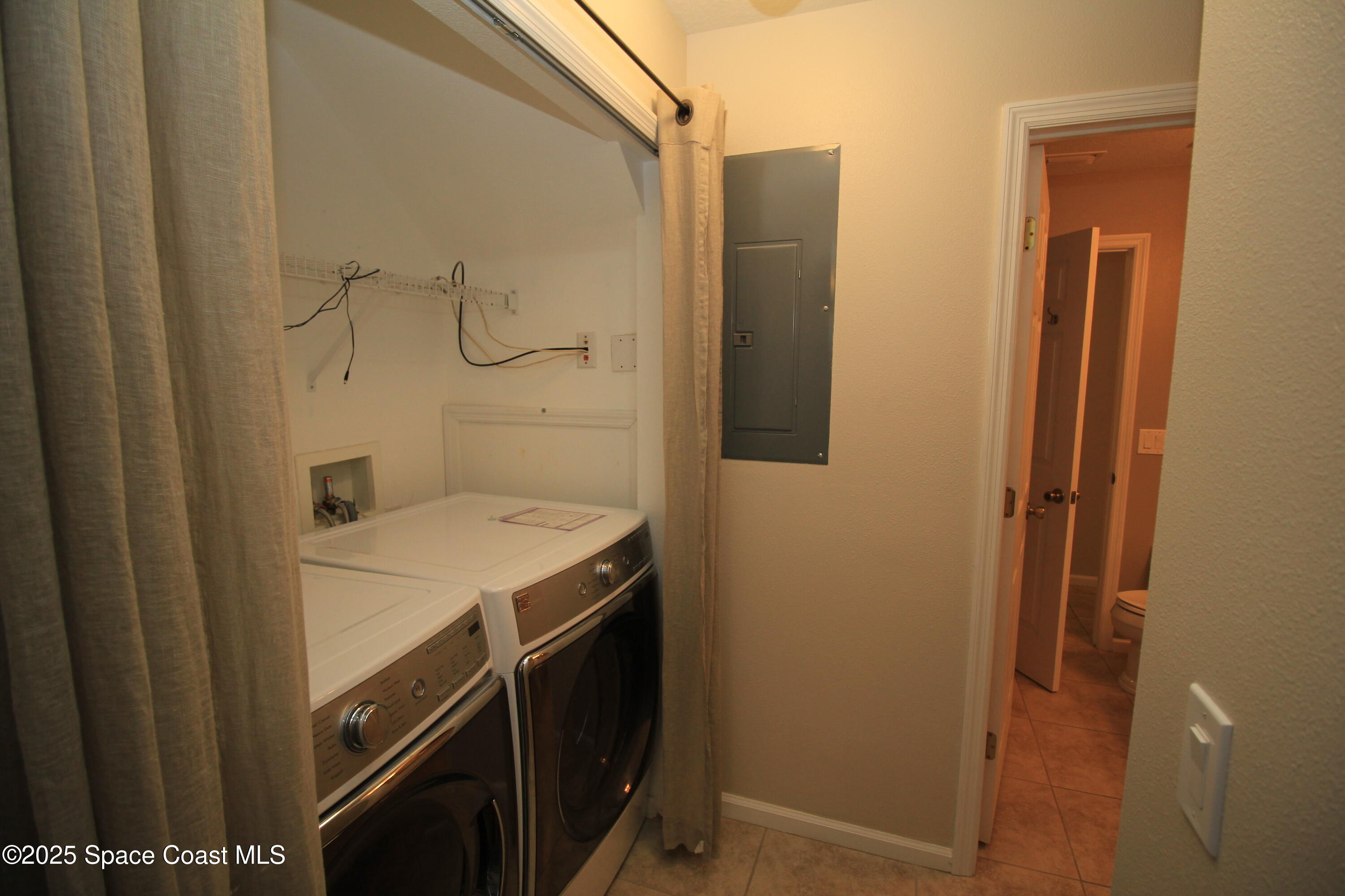 1075 Luminary Circle, Unit 102 Melbourne, FL 32901 - Photo 8 of 18 a utility room with dryer and washer