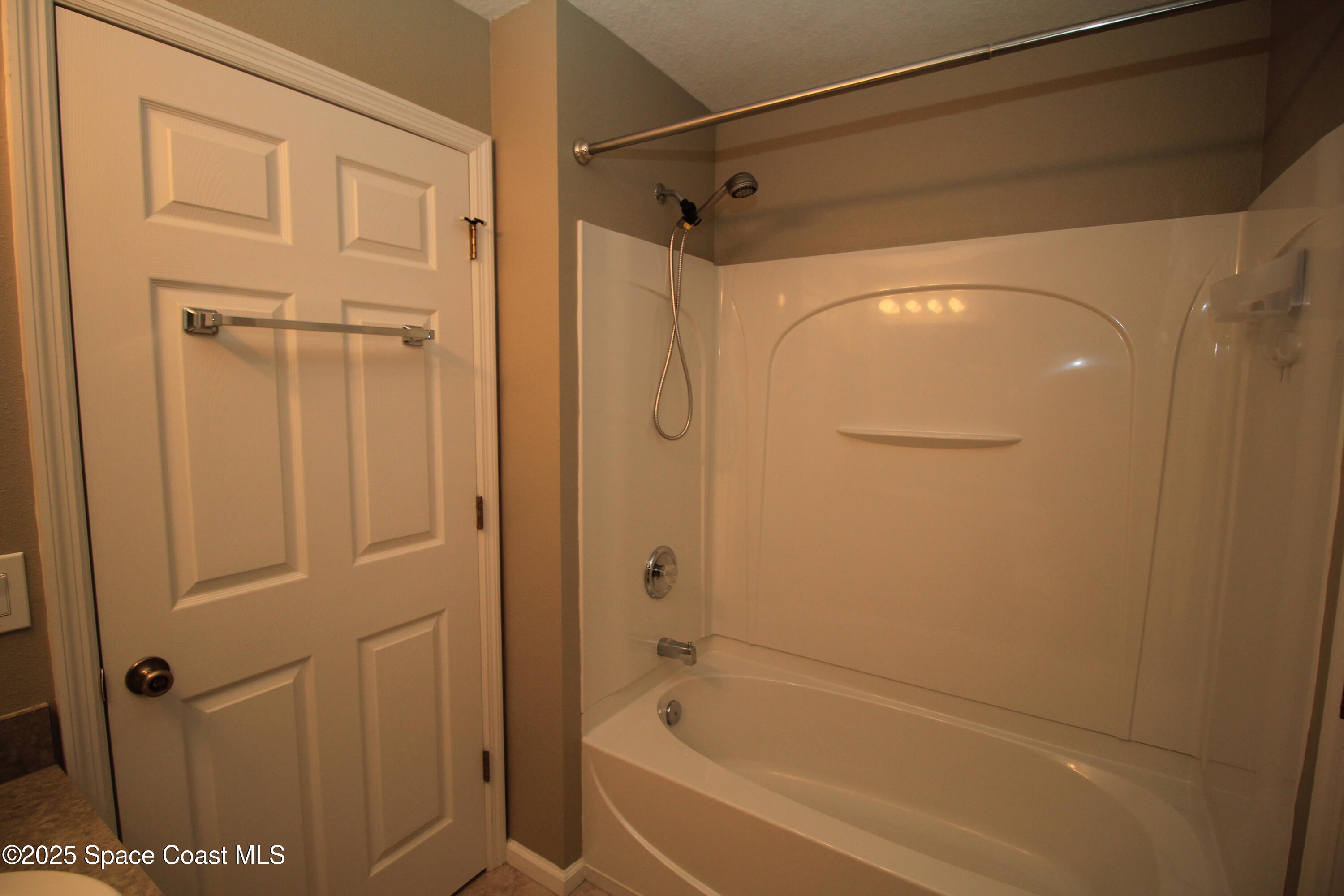 1075 Luminary Circle, Unit 102 Melbourne, FL 32901 - Photo 10 of 18 a bathroom with a bathtub and a shower
