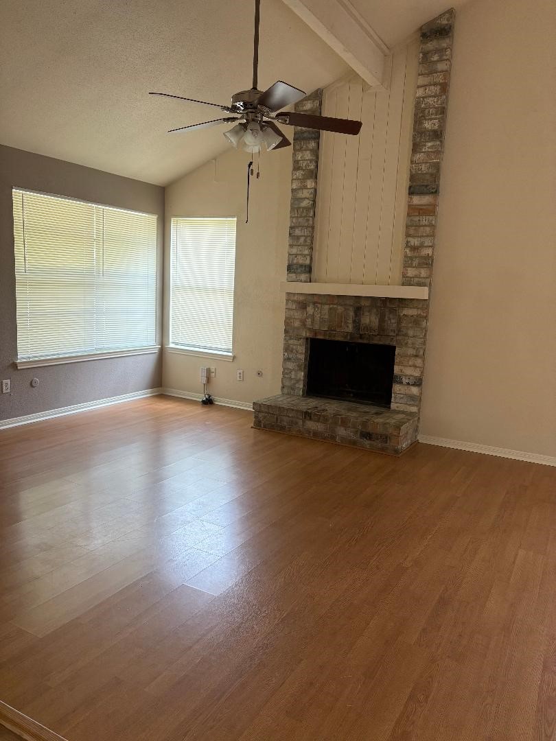 9111 Woodhouse Drive Spring, TX 77379 - Photo 3 of 7 a view of empty room with fireplace and windows
