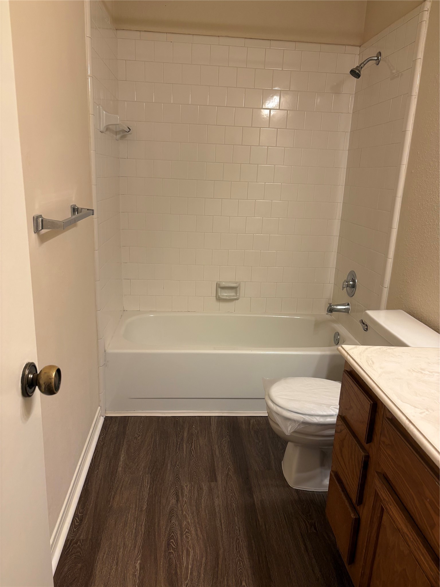9111 Woodhouse Drive Spring, TX 77379 - Photo 4 of 7 a bathroom with a granite countertop toilet a sink and shower