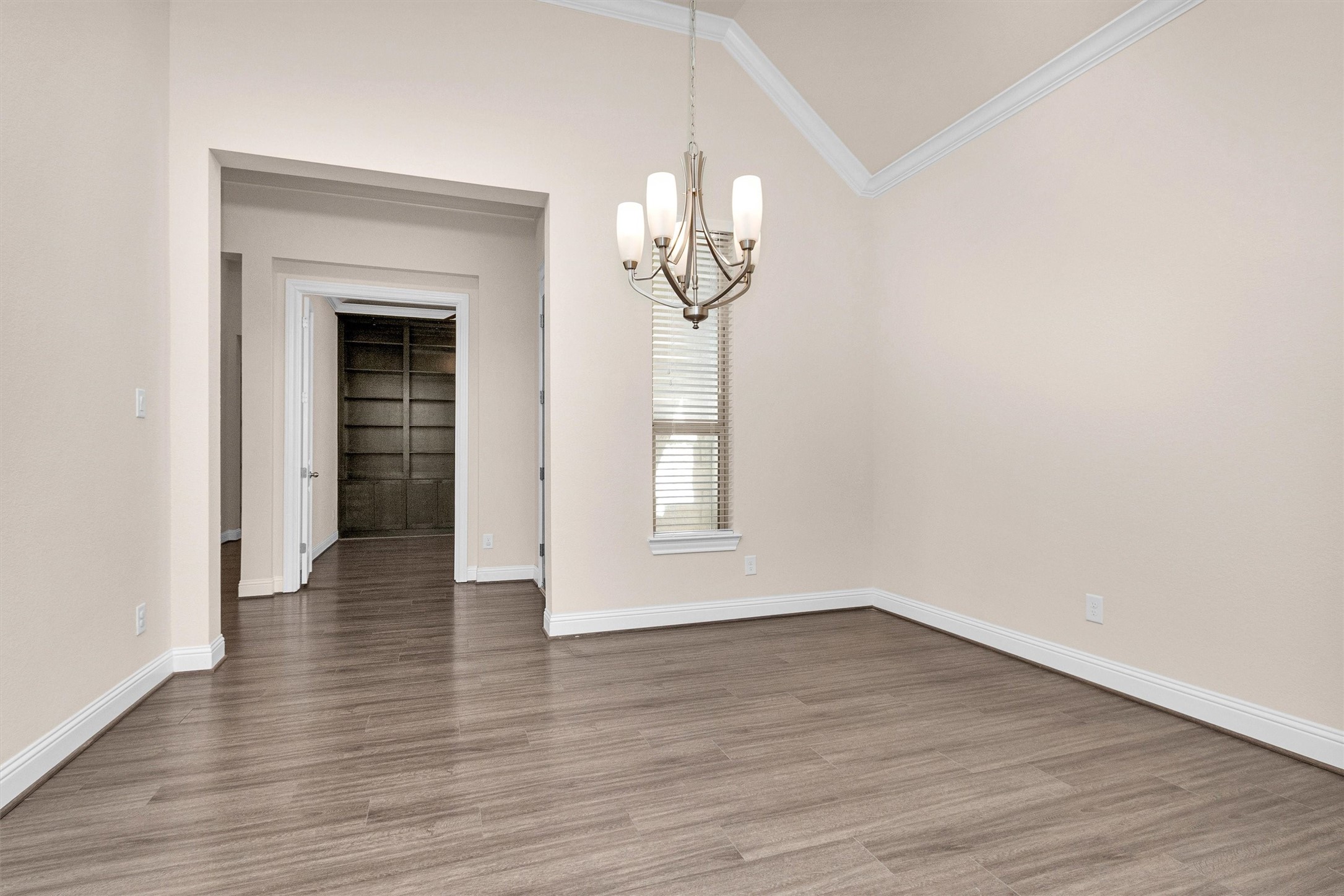 20707 Stillhaven Road Spring, TX 77379 - Photo 12 of 50 a view of an empty room with wooden floor and a window