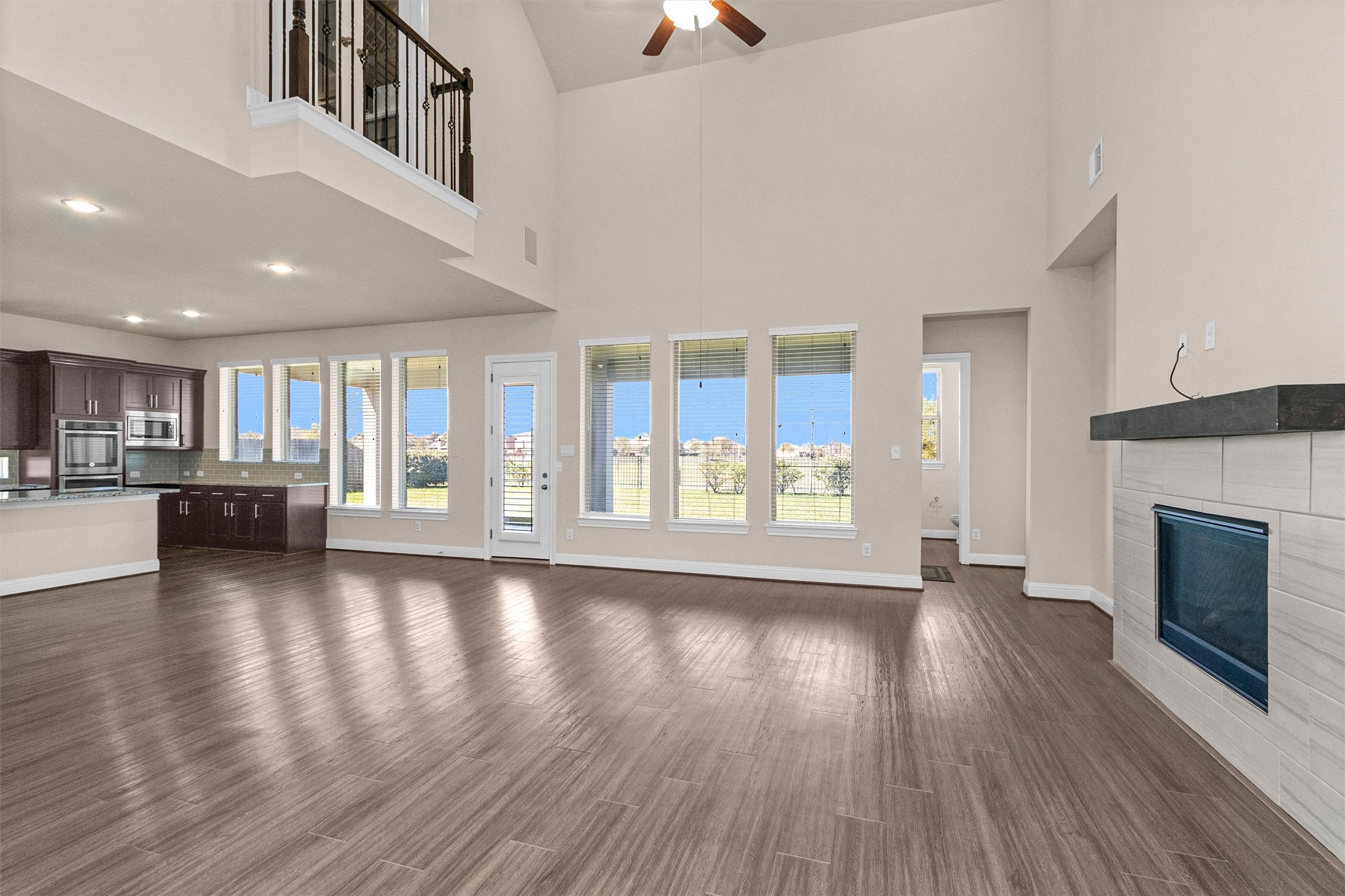 20707 Stillhaven Road Spring, TX 77379 - Photo 16 of 50 a view of an empty room with wooden floor fireplace and a window
