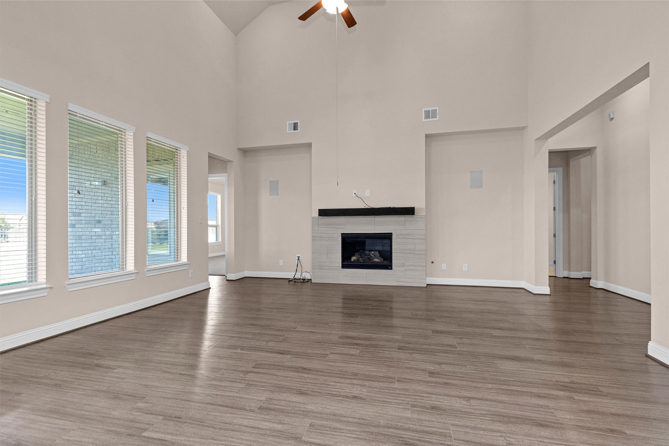 20707 Stillhaven Road Spring, TX 77379 - Photo 17 of 50 wooden floor fireplace and windows in an empty room