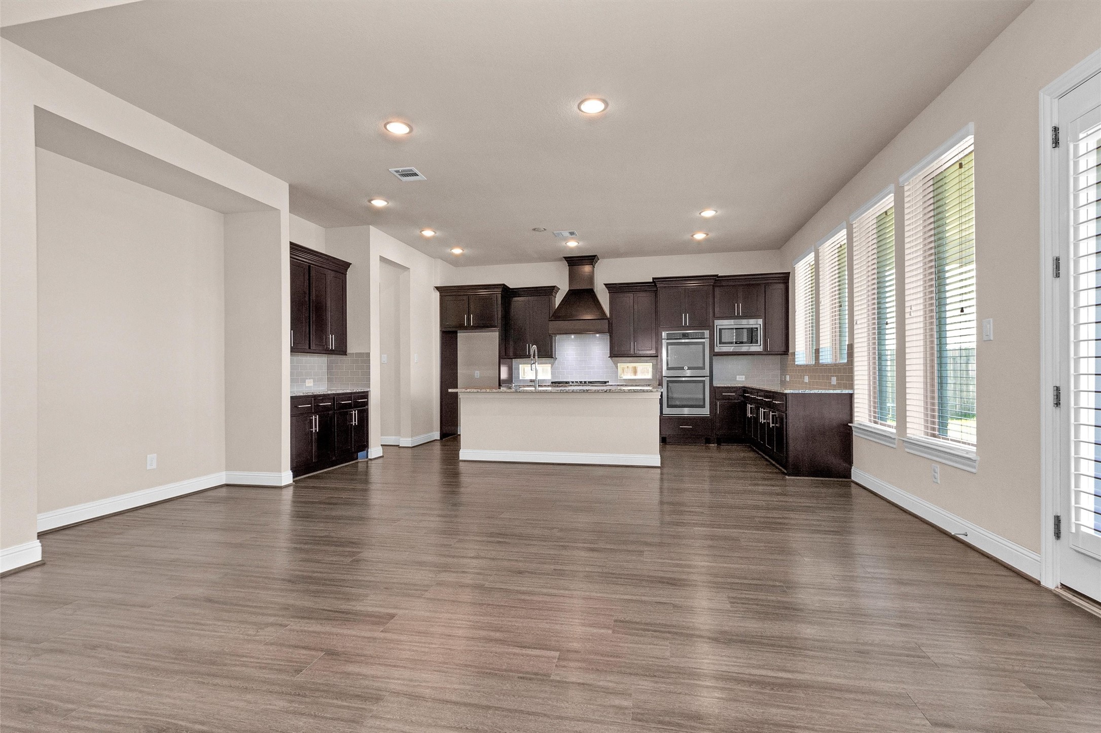 20707 Stillhaven Road Spring, TX 77379 - Photo 19 of 50 a view of kitchen with kitchen island wooden floors and refrigerator