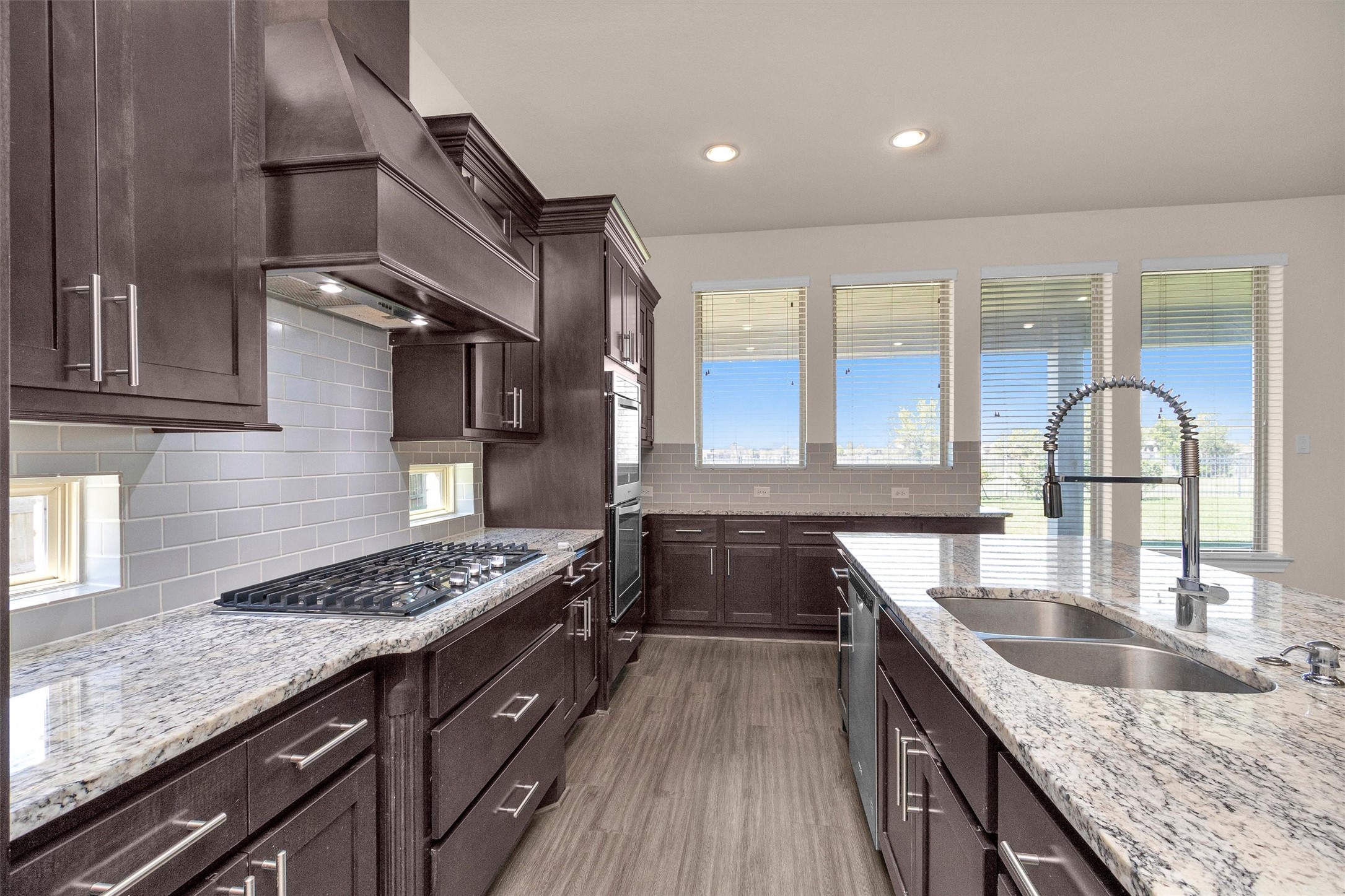 20707 Stillhaven Road Spring, TX 77379 - Photo 21 of 50 a kitchen with granite countertop a sink stove and cabinets