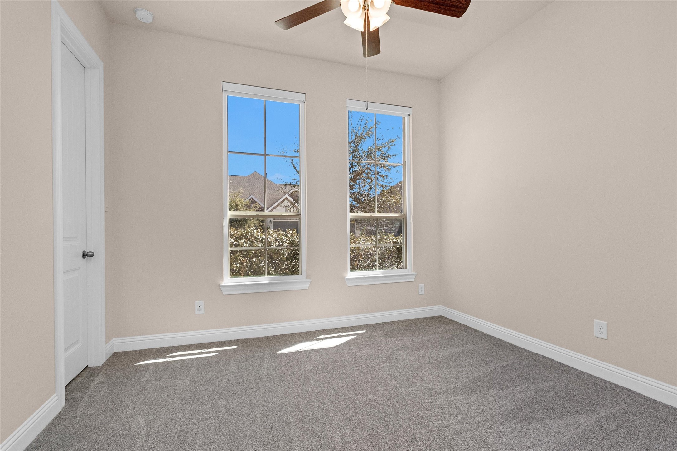 20707 Stillhaven Road Spring, TX 77379 - Photo 31 of 50 an empty room with chandelier fan and windows