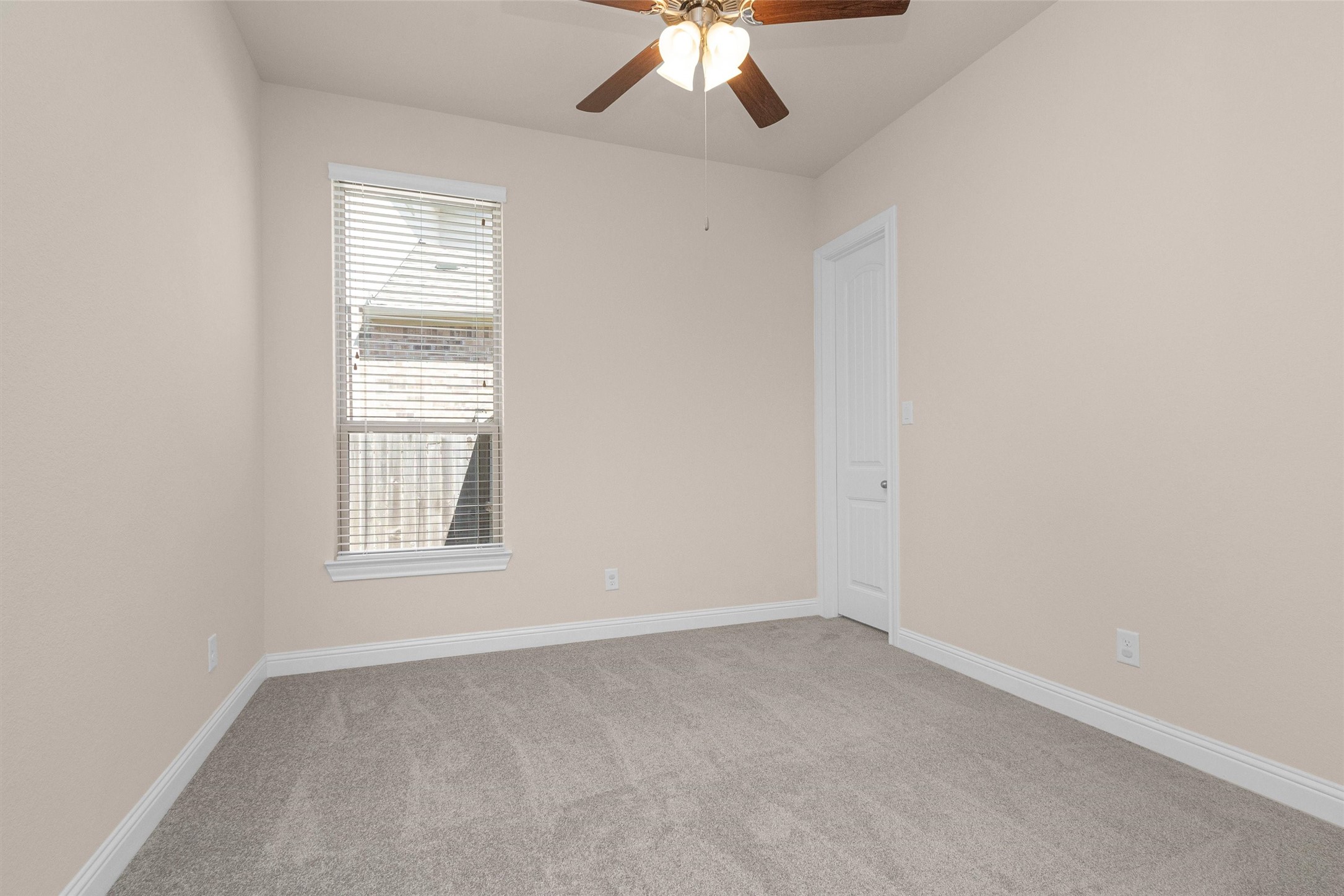 20707 Stillhaven Road Spring, TX 77379 - Photo 33 of 50 an empty room with a window and a fan